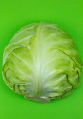 Green cabbage on the green background. Close up. Macro photo. Minimalism, original beautiful food photo.