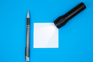 Blank white To Do List Sticker with flashlight and pen. Searching information on the Internet....