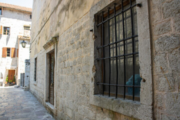 Charming streets of medieval сity. Details of architecture in the old town. Travel Kotor Montenegro. Vintage background.