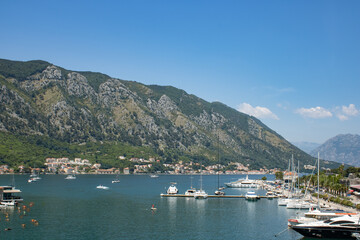 Fototapeta na wymiar Beautiful sea and mountain views under the bright blue sky. View to the Kotor bay Montenegro to Adriatic sea.