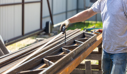 A worker changes metal pipes