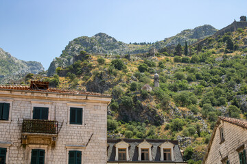 Old town of Kotor Montenegro on the background of mountains and blue sky. The bright beautiful landscape of  against the background of mountains in the summer on a clear day