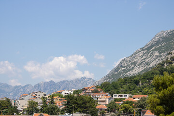 Obraz premium Old town of Kotor Montenegro on the mountains and blue sky background. The bright beautiful landscape in the summer on a clear day.