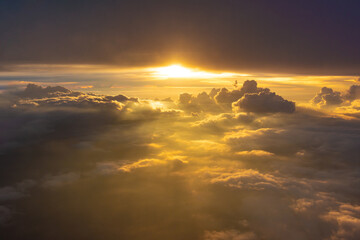 Beautiful dramatic bird eye view of cloudscape with sunset as seen from a plane