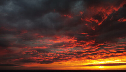 Beautiful contrasting sunset with purple clouds in the evening sky