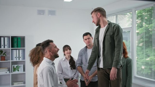 support, a young man falls on his back trusting his male and female colleagues during a therapy session