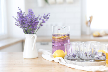 Fototapeta na wymiar Preparation of fresh lavender lemonade. Step 7, ingredients for a making summer fresh cocktail. User's guide. Drink in the kitchen.