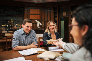 Students preparing exam and learning lessons in school library