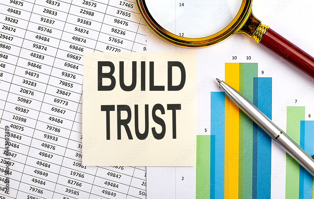 Poster business concept. top view of stiscker with text build trust on chart background