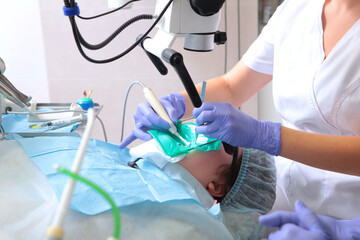 Dental treatment with a microscope.Modern dentistry. Accurate treatment of complex diseases.