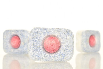 Three dishwasher tablets, close-up, isolated on white.