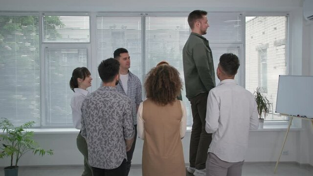 Confidence And Trust, A Young Man Falls Back Into The Arms Of His Male And Female Colleagues During A Therapy Session