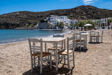 Greek island outdoor tavern table by the sea, sunny day