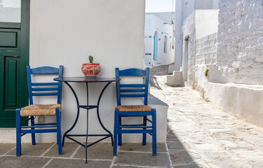 Greek island outdoor cafe table, sunny day