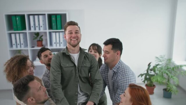 confidence and trust, young team catches and applauds their male colleague during group therapy session