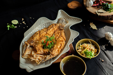 Deep fried seabass fish in fish sauce (Thai food) - Asian food style