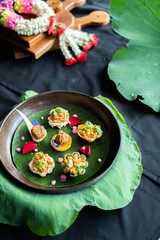 Thai traditional food and handmade garland on lotus pad (leaf) - Asian food style