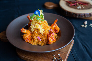 Fried crispy rice vermicelli with shrimp on wooden board - Asian food style