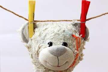 toy teddy bear hanging on clothesline