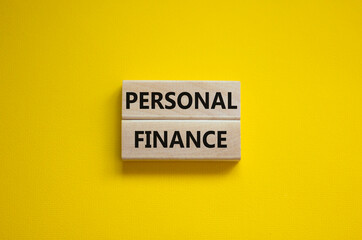 Personal finance symbol. Wooden blocks with words Personal finance on beautiful yellow background,...
