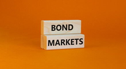 Bond markets symbol. Wooden blocks with words 'Bond markets' on beautiful orange background, copy space. Business and bond markets concept.