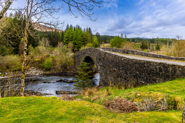 A view from the village beside the Bridge of Orchy near to Glencoe, Scotland on a summers day - Powered by Adobe