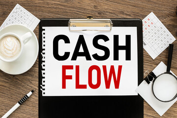 Cash Flow. text on wood table, on white paper