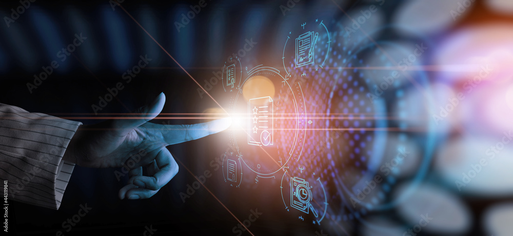 Poster ERP, document management concept.Businessman working with modern computer with icons on virtual screen and office blur background.