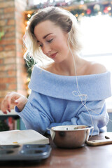 The blonde girl is relaxing in the kitchen and shooting photos