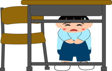 地震で机の下に隠れる男の子