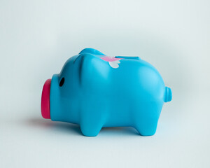 piggy bank blue color on a white background. Couple toy saving money