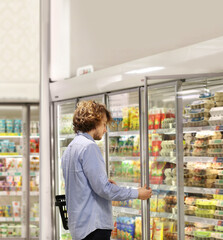 Fototapeta na wymiar choosing frozen food from a supermarket freezer.