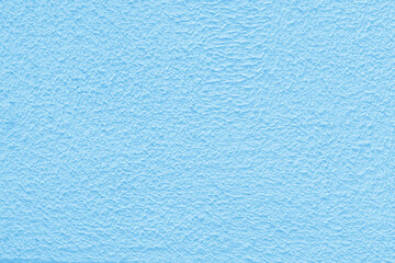 Blue plaster wall of a building. Rough surface texture.