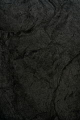 The texture of black rough stone. Abstract dark background.