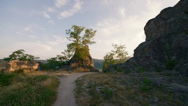 Glide track through ancient ruins location in Ruine D&uuml;rnstein. Road towards ruined abandoned Castle on tops of stone rocks in hilltop.