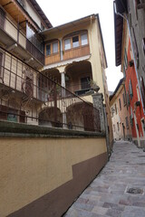 narrow street in an old village with colorful buildings in Ticino