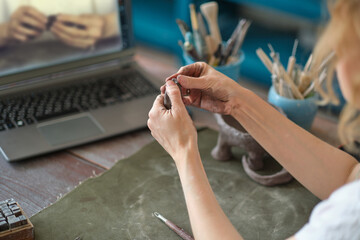 artisan pottery tutor in art studio. woman ceramist teaches an online lesson or leads a video master class on creating ceramic products