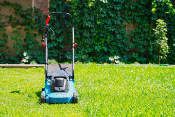 Lawnmower electric machine trimming green grass. Lawn cutting