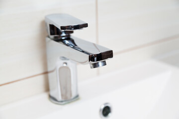 Steel mixer close-up on modern sink