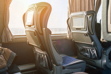 Intercity bus interior with seat-mounted interactive touchscreen © andrei310