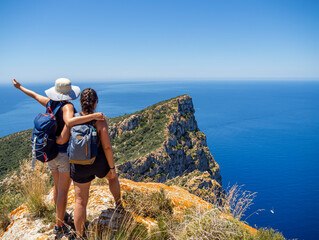 Hiking friends on a mountain top. Outdoor trekking in Mallorca island, adventure lifestyle. Enjoy...