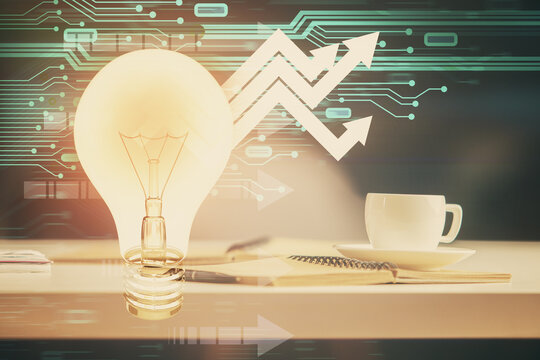 Double exposure of bulb drawing and desktop with coffee and items on table background. Concept of ideas.