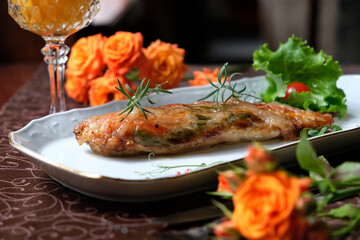 Baked juicy meat in glaze. Greens. A tomato