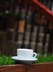White cup with a hot drink on the background of a cozy restaurant. 