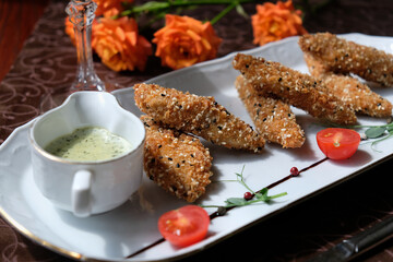 pieces of tender meat in special breading with sauce