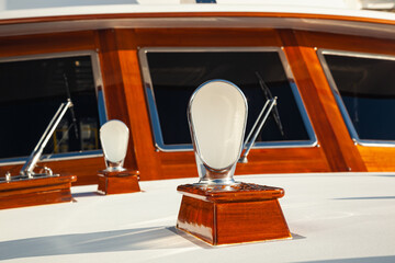 Windshields with windshield wipers on a yacht, front view. Luxury yacht in wooden decoration, front view, close-up.