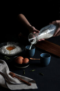 Hands of anonymous woman pouring milk