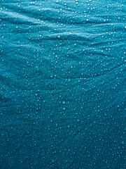 Water drops on waterproof membrane fabric. Morning dew on tent.