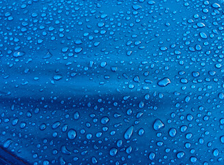 Fototapeta na wymiar Water drops on waterproof membrane fabric. Morning dew on tent.