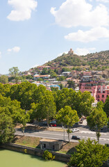Tbilisi, Georgia-August 07, 2013: Embankment of the Mtkvari river and historic Sololaki district in Tbilisi. Summer day - 443131293